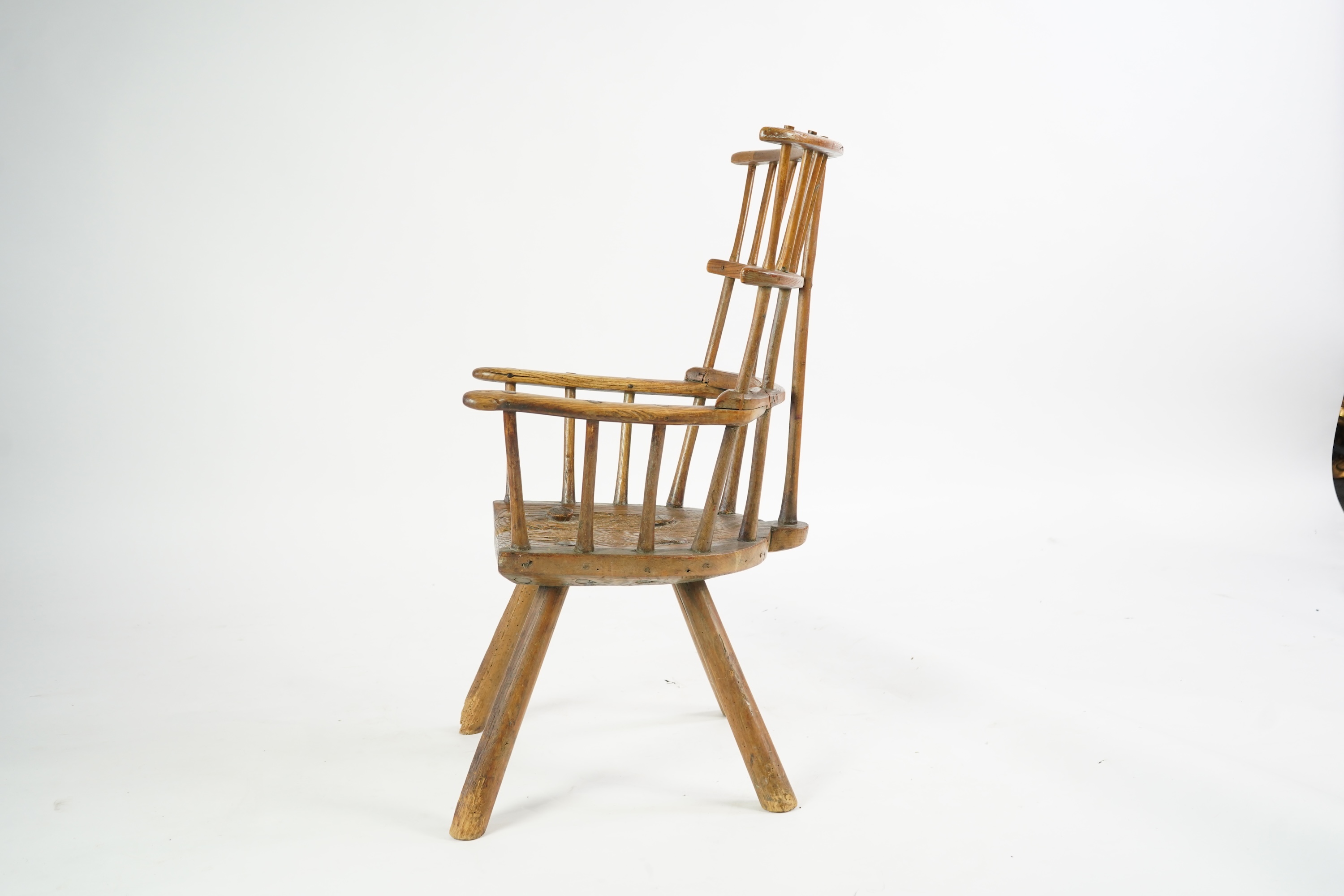 An 18th or 19th century primitive ash and elm Windsor armchair